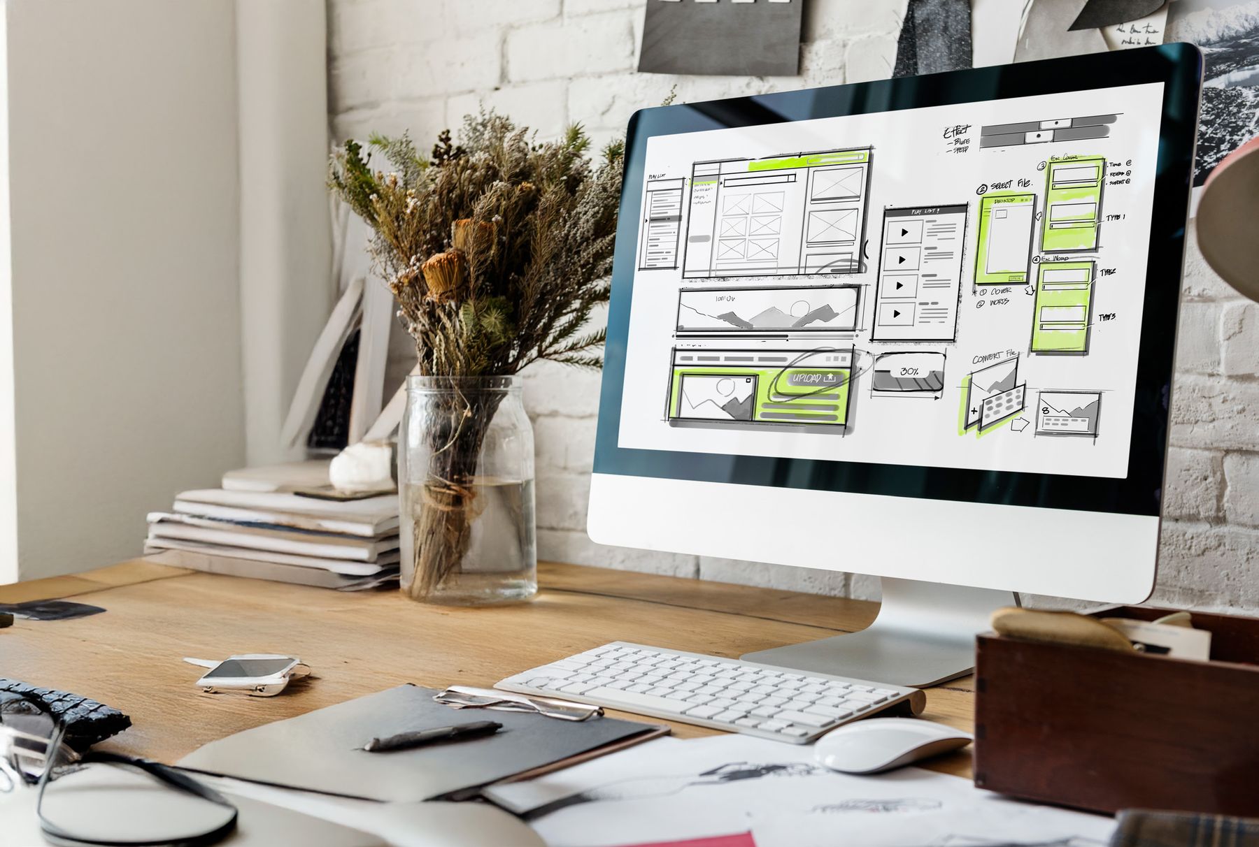 Website layout wireframes sketched at a desk
